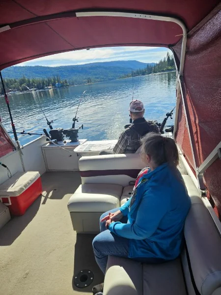 Guests relaxing aboard the fishing barge while trolling Bass Lake