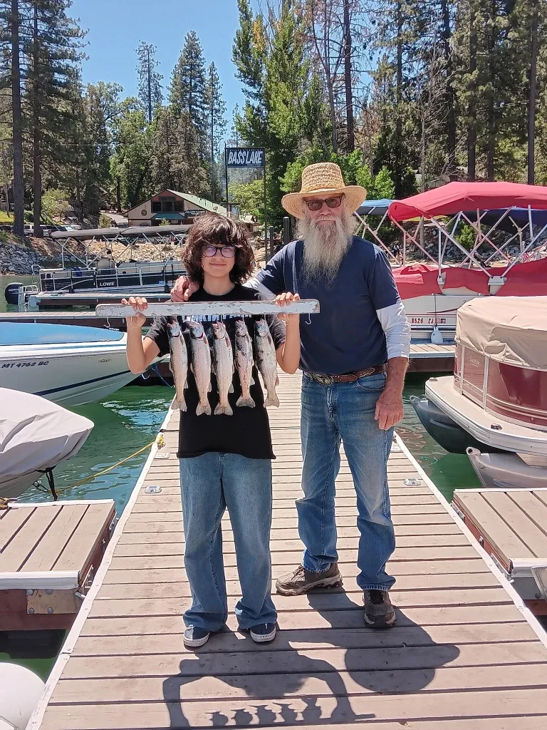 Mike Beighey, expert fishing guide at Bass Lake, teaching a young angler how to fish